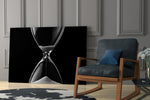 Hourglass Time artwork anchoring a wall with moody philosophical palette