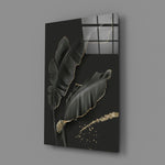 Leaf close-up showing dark banana leaves with gold-traced edges