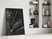 Leaf artwork anchoring a wall with moody luxury palette