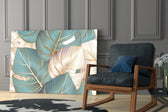 Leaves artwork anchoring a wall with calm tropical palette