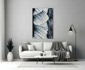 Abstract glass wall art styled above a coffee table in a living room