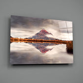 Mountain close-up showing rust-red volcanic peak mirrored on still water