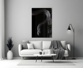 Snake glass wall art styled above a credenza in a gaming room