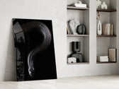 Snake artwork anchoring a wall with bold mysterious palette