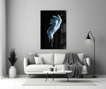 Hand glass wall art styled above a console in a gaming room