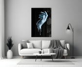 Hand glass wall art styled above a console in a gaming room