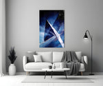 Abstract glass wall art styled above a credenza in a living room