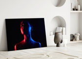 Women's glass wall art styled above a sofa in a bedroom