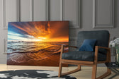 Sunset artwork anchoring a wall with serene coastal palette