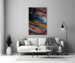 Abstract glass wall art styled above a credenza in a living room