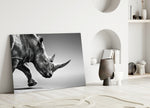 Black Rhino glass wall art styled above a console in a living room