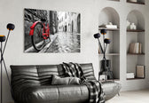 Street and Bicycle glass wall art styled above a sofa in a living room