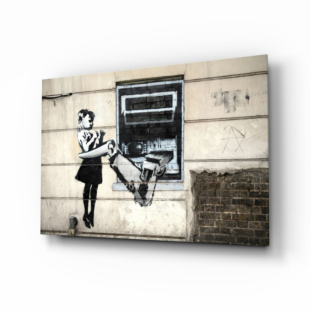 Future ATM glass wall art displayed above a tan leather sofa in a brick-walled industrial lounge with concrete floor and matte-black coffee table