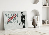 Plans Cancelled close-up showing painter beside Follow Your Dreams Cancelled red stamp