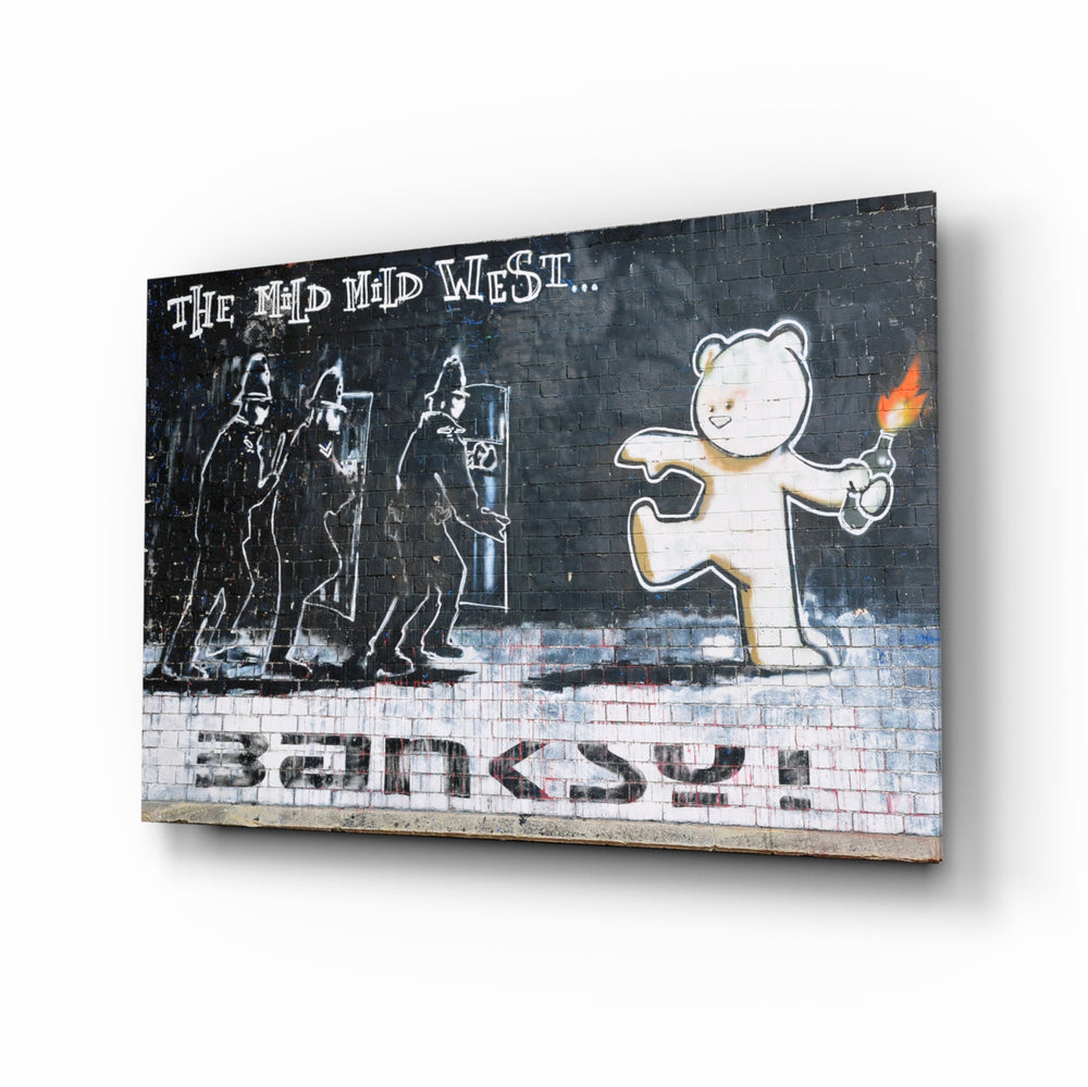 Bear's Resistance glass wall art displayed above a tan leather sofa in a brick-walled lounge with reclaimed-wood coffee table and matte-black floor lamp