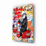 Monkey Advice glass wall art displayed above a black gaming sofa in a brick-walled lounge with neon arcade sign and reclaimed-wood console