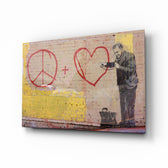 Graffiti Doctor glass wall art displayed above a tan leather sofa in a goldenrod-painted lounge with reclaimed-wood coffee table and brass picture light