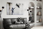 War Kite glass wall art styled above a sofa in a living room