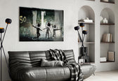 TV Heads glass wall art styled above a sofa in a gaming room