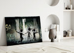 TV Heads close-up showing three TV-set figures dancing on graffitied wall