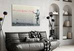 What We Do in Life glass wall art styled above a console in a hallway