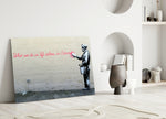 What We Do in Life close-up showing painter spraying pink Eternity quote on cream brick