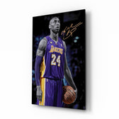 Kobe Bryant glass wall art displayed above a tufted leather chair in a man cave with basketball shelves and brushed-brass sconces