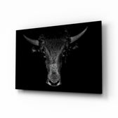 Buffalo glass wall art displayed above a charcoal leather chesterfield in a slate-walled man cave with reclaimed-wood console and brass desk lamp