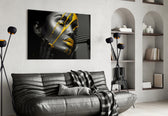Yellow Paint glass wall art styled above a bed in a bedroom