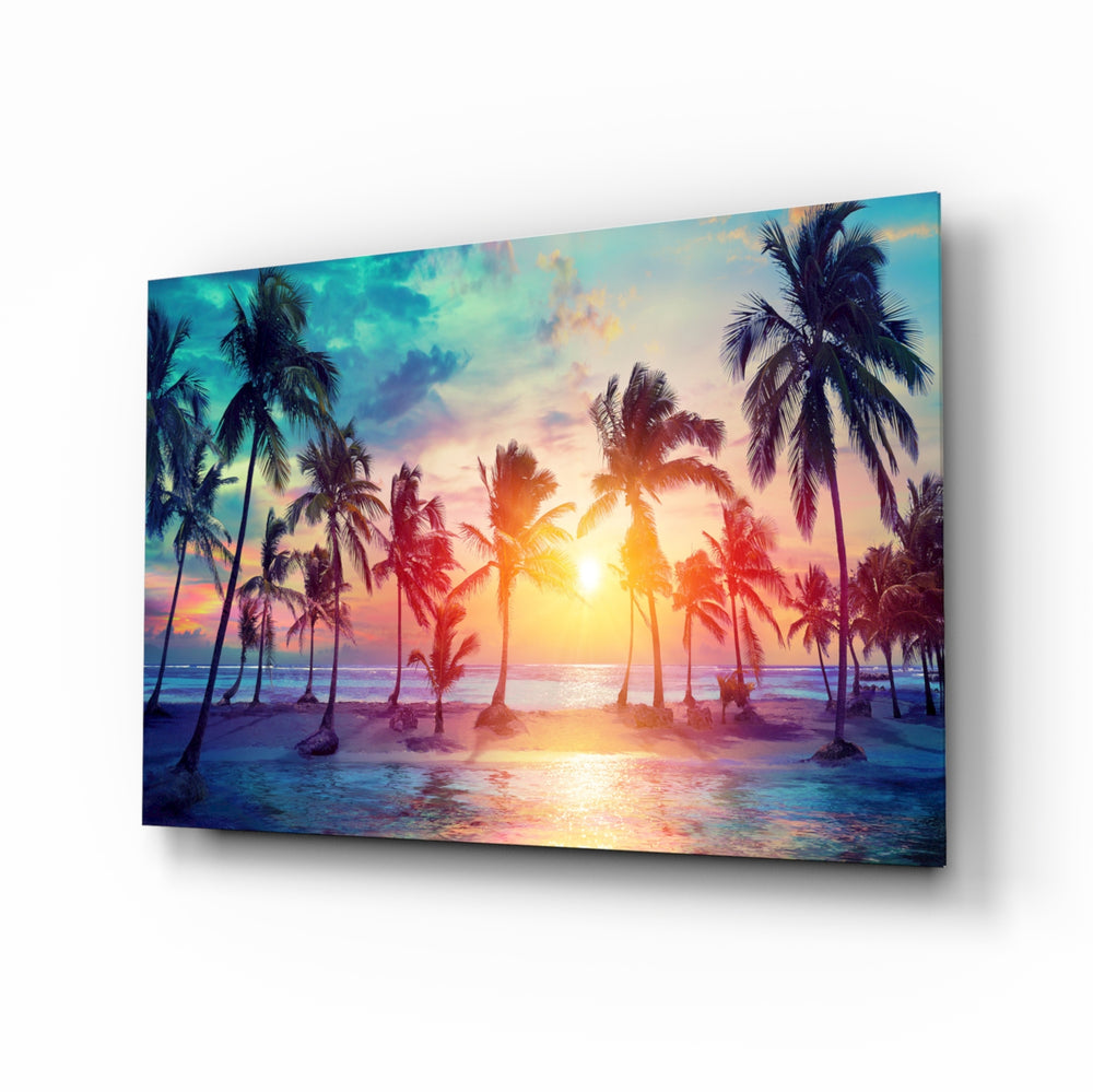 Sunset and Palms glass wall art displayed above a linen bed in a soft-blush bedroom with rattan nightstands and brushed-brass sconces