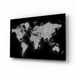 World Map glass wall art displayed above a charcoal sofa in a slate-walled lounge with steel-frame coffee table and matte-black floor lamp