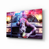 Harley Quinn glass wall art displayed above a black gaming sofa in a neon-lit gaming room with RGB chair and matte-black shelves
