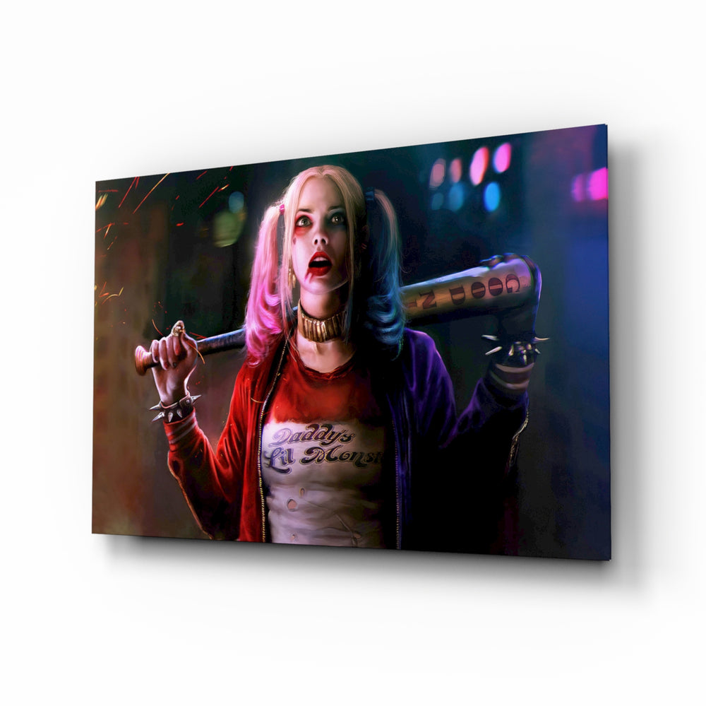 Harley Quinn glass wall art displayed above a black gaming sofa in a brick-walled lounge with neon arcade sign and matte-black coffee table