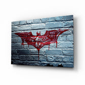 Batman glass wall art displayed above a black gaming sofa in a brick-walled lounge with neon arcade sign and reclaimed-wood console