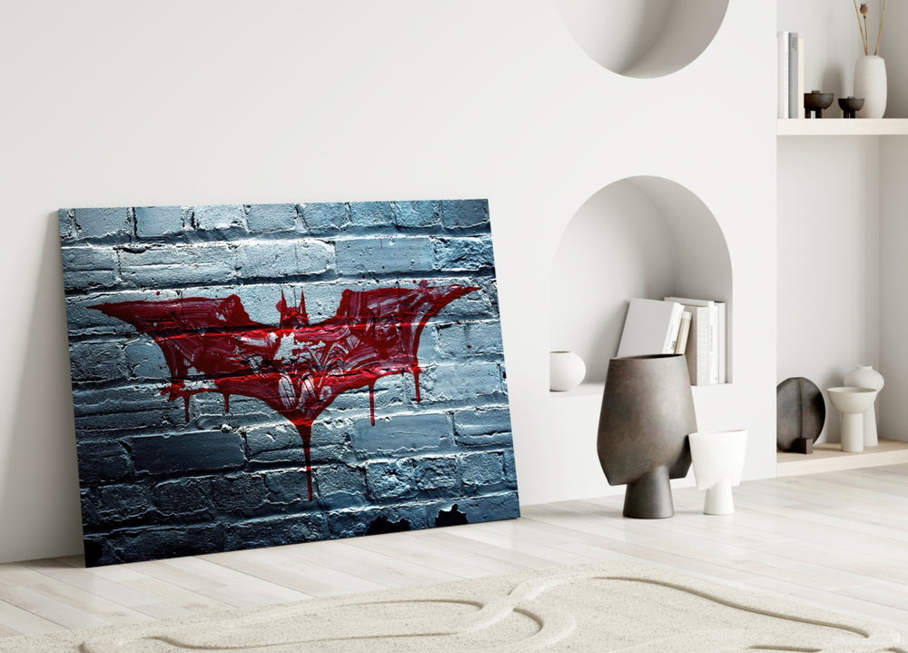 Batman close-up showing crimson bat logo dripping across white-painted brick