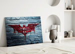 Batman close-up showing crimson bat logo dripping across white-painted brick