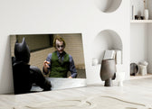 Interrogation close-up showing the Joker leaning toward Batman across cell-block table