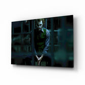 Joker Jail glass wall art displayed above a leather sofa in a slate-walled home theater with reclaimed-wood console and projector screen