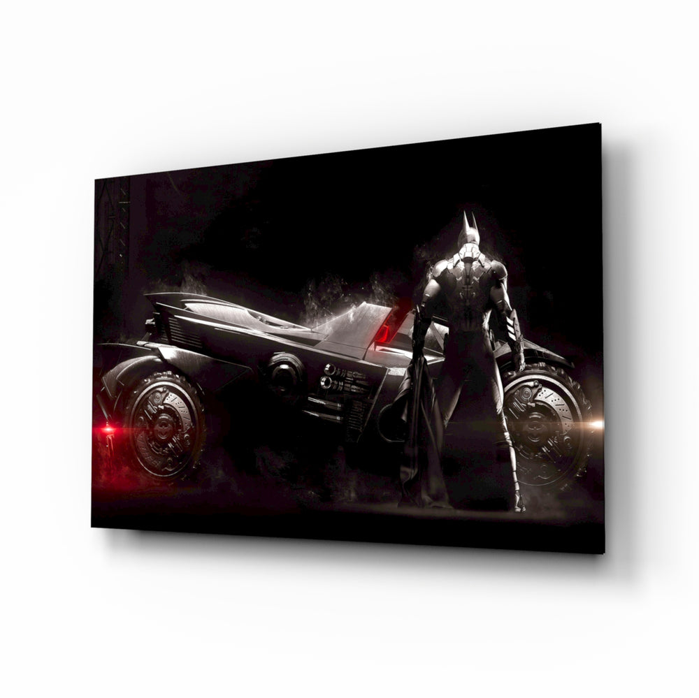 Batmobile glass wall art displayed above a black gaming sofa in a brick-walled lounge with neon arcade sign and matte-black coffee table