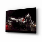 Batmobile glass wall art displayed above a black gaming sofa in a brick-walled lounge with neon arcade sign and matte-black coffee table