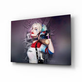 Harley Quinn glass wall art displayed above a charcoal sofa in a slate-walled office lounge with steel desk and matte-black shelving