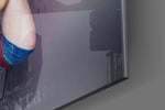 Harley Quinn artwork anchoring a wall with dark dramatic palette