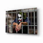 Joker glass wall art displayed above a leather chesterfield in a slate-walled home theater with reclaimed-wood console and projector screen