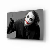 Joker glass wall art displayed above a leather chesterfield in a brick-walled home theater with reclaimed-wood console and projector screen