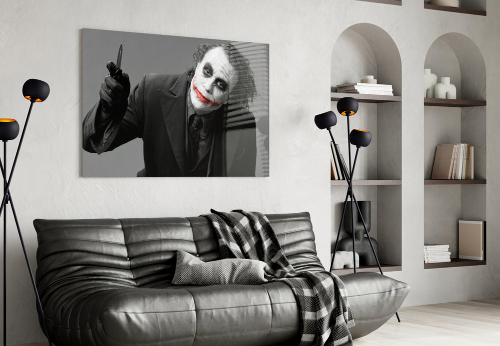 Joker glass wall art styled above a sofa in a gaming room