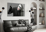 Joker glass wall art styled above a sofa in a gaming room