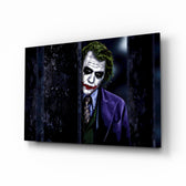 Joker glass wall art displayed above a leather chesterfield in a brick-walled home theater with reclaimed-wood console and projector screen