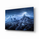 Imposing Mountains glass wall art displayed above a charcoal sofa in a slate-walled lounge with reclaimed-wood coffee table and matte-black floor lamp
