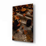 Autumn Picnic glass wall art displayed above a walnut buffet in a copper-toned dining room with cane chairs and brass pendant lamp