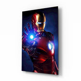 Iron Man glass wall art displayed beside a black gaming sofa in a brick-walled lounge with neon arcade sign and matte-black coffee table